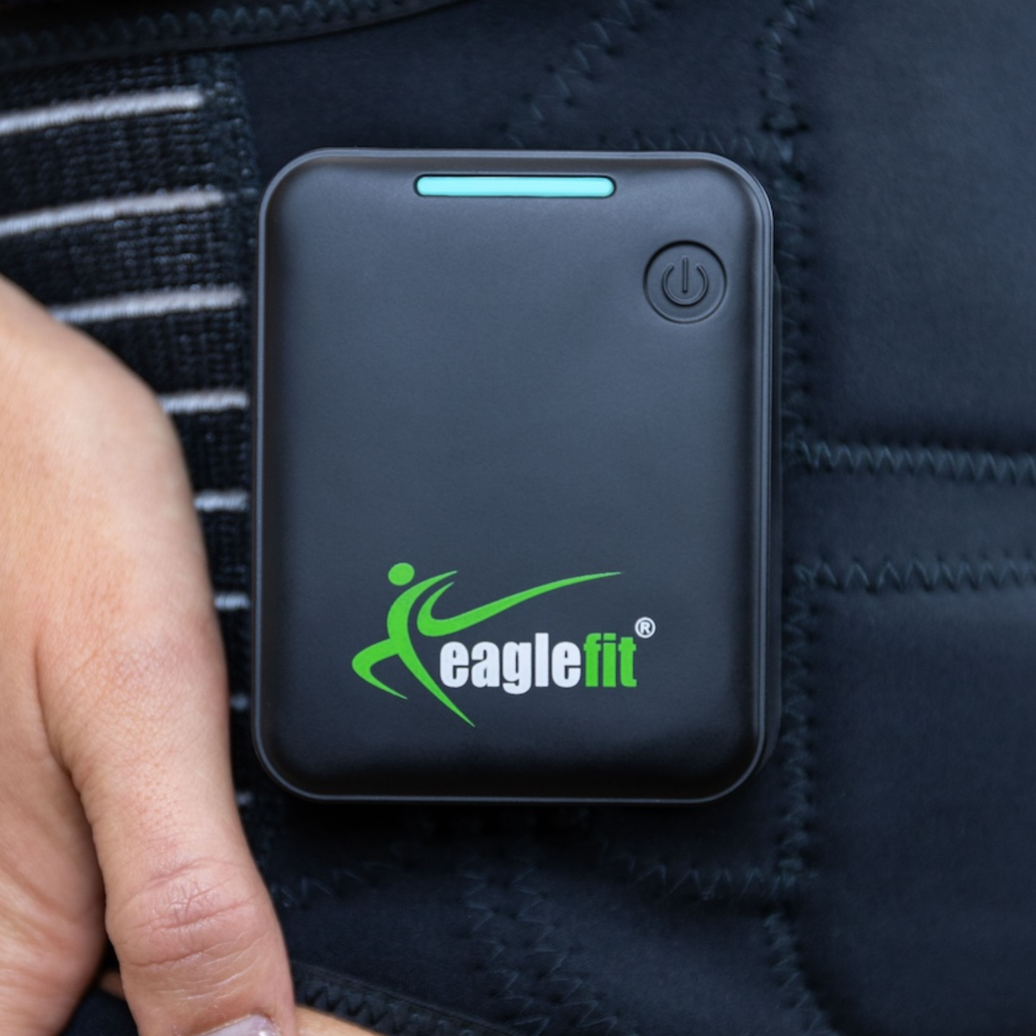 eaglefit EMS BELT 2.0 control unit for abdominal and lower back training, attached to clothing.